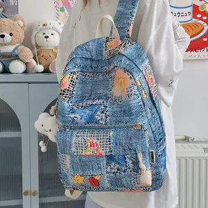 Mini denim patchwork backpack for girls with floral embroidery and cloud charm accessory