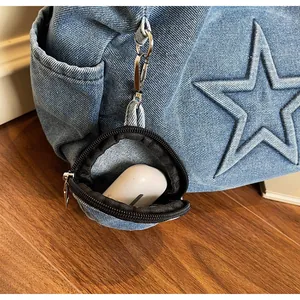 Detail of light blue denim tote bag with star stitching and detachable mini round coin purse