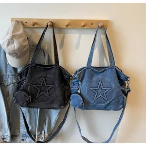 Detailed view of denim tote bags with embossed star pattern and matching mini coin pouches