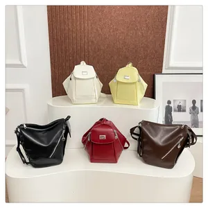 Collection of minimalist faux leather backpacks in five neutral colors on display