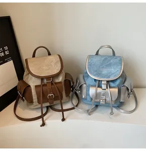 Detailed close-up showing the suede texture and metal buckle accents on retro backpacks