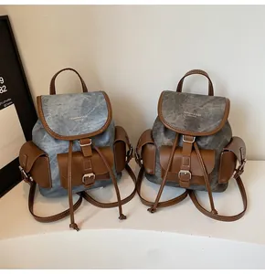 Detail view of vintage bucket backpacks with drawstring closures and leather patchwork details