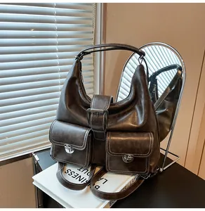 Detail of dark brown vintage hobo bag with dual front pockets and silver twist locks