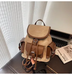 Detail of vintage beige and brown contrast backpack with drawstring and buckle closure