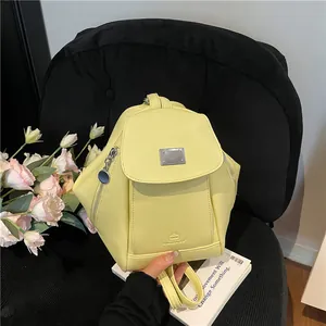 Light yellow PU leather backpack with geometric hexagon design and silver metal accents