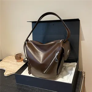 Dark brown leather multi-pocket bucket bag presented in a premium gift box setup
