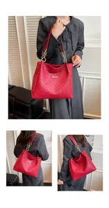 Detail of red woven texture tote bag with gold chain link straps and professional styling