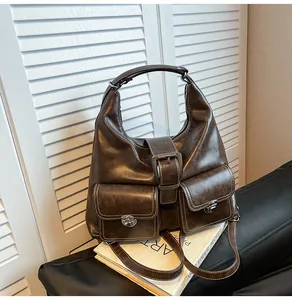 Detail of dark brown vintage faux leather shoulder bag with white contrast stitching