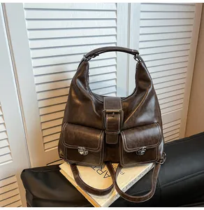 Close-up of retro brown backpack featuring dual front pockets and white contrast stitching