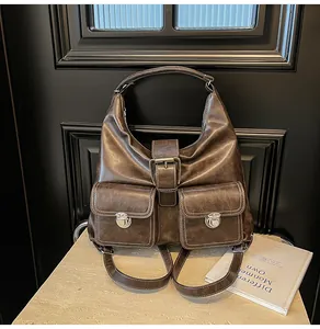 Macro shot of dark brown leather texture and silver metal buckles on retro tote backpack