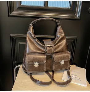 Detail of vintage brown faux leather backpack with metallic buckle and flap pockets