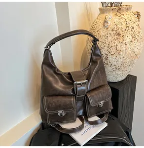 Detail shot of vintage dark brown faux leather hobo bag with front flap pockets