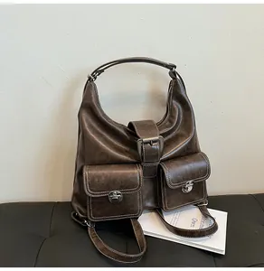 Detail of vintage brown leather bag with contrast stitching and silver twist locks
