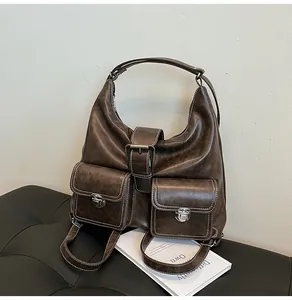 Detail of vintage brown tote bag featuring white contrast stitching and silver hardware