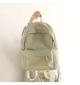 Close-up of waterproof Oxford fabric backpack with front zipper pocket and leather logo