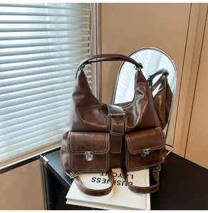 Close-up of retro brown leather backpack with contrast stitching and silver buckles