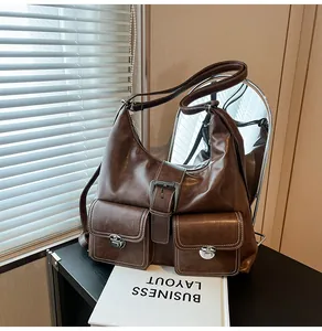 Detailed view of deep brown faux leather tote with metallic twist locks and front pockets
