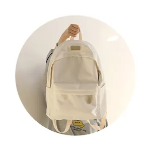 Detail of waterproof Oxford backpack showing the front leather label and durable texture