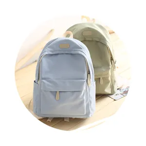 Close-up of waterproof Oxford fabric backpacks in light blue and green colors