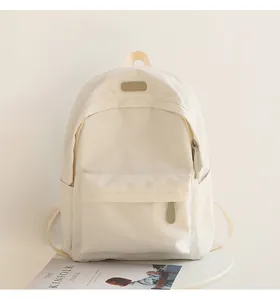 Minimalist cream white waterproof backpack shown with Kinfolk magazine on white table