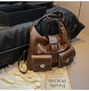 Detail of dark brown vintage faux leather tote bag with white stitching and pockets
