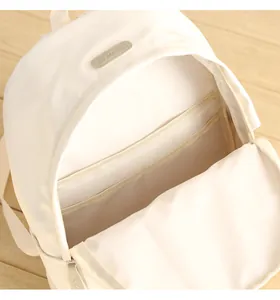 Macro view of the cream-white backpack interior showing layered storage compartments