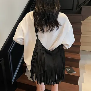 Bohemian black frosted suede shoulder bag with long tassels in a vintage autumn style