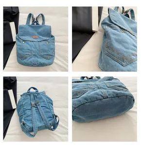 Detail view of washed blue denim backpack with adjustable straps and front pockets