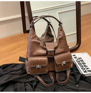 Close-up of vintage brown hobo bag with contrast stitching and metal buckle detail