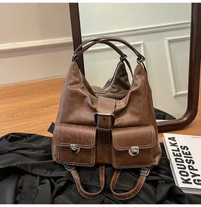 Macro detail of brown leather texture with white contrast stitching and silver metal snaps
