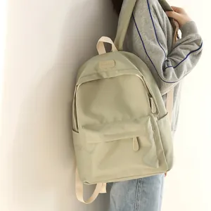Minimalist light green waterproof oxford backpack with large front pocket and leather label