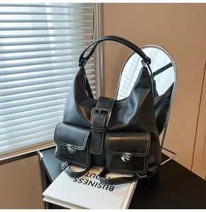 Macro detail of vintage black tote with white stitching and metallic turn-lock pockets
