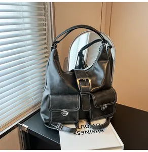 Close-up of vintage tote bag with white contrast stitching and metallic buckle details