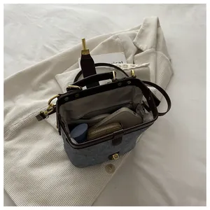 Close-up of the spacious inner compartment and elegant gold buckle of the doctor bag