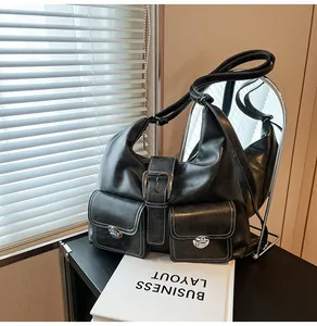 Detail of vintage black faux leather bag with contrast stitching and metallic buckles