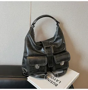 Detail of vintage black bag with white contrast stitching and silver metal locks