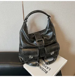 Retro black leather hobo bag with dual front flap pockets and silver metal buckles