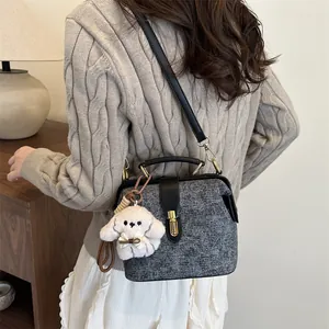 Quilted tweed handbag in grey with black leather handle and plush puppy pendant accessory