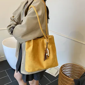 Retro yellow suede tote bag with wooden bead charm and long shoulder strap for women