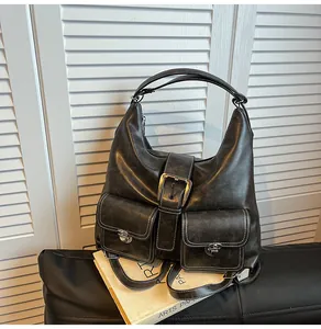 Detail view of large dark grey vintage tote bag with contrast stitching and metal buckles
