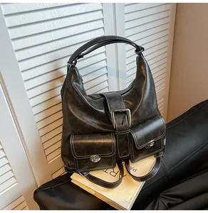 Detail of vintage black faux leather tote bag with white contrast stitching and large buckle