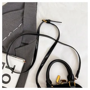 Détail du sac coquillage noir mat avec fermeture éclair dorée et texture cuir élégante