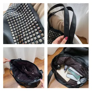 Detail view of large black rivet tote bag showing inner pockets and silver stud accents