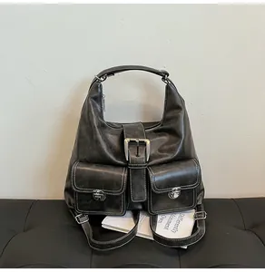 Detail of vintage grey PU leather hobo bag with white stitching and silver buckles