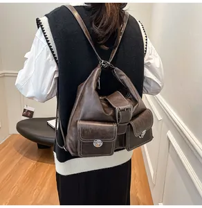 Detailed back view of a vintage dark brown PU leather backpack with silver metal buckles