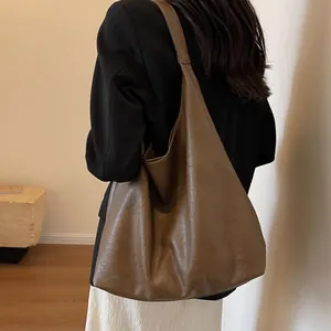 Minimalist large brown leather tote bag for women showing vintage shoulder carry style