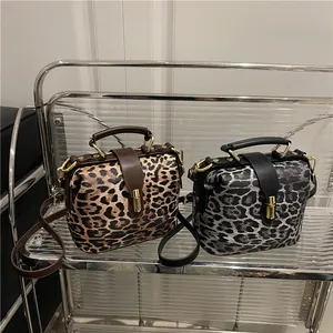 Leopard print crossbody bags in brown and grey with gold locks and top handles