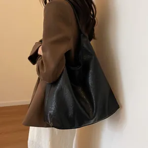 Large black crescent tote bag in wrinkled PU leather for casual commute outfits