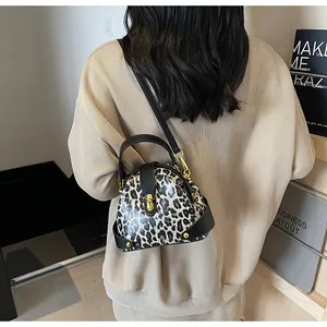 Model view showing the compact size and leopard print texture of this stylish crossbody bag