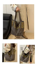 Gros plan détaillé des rivets sur un grand sac cabas en daim gris élégant